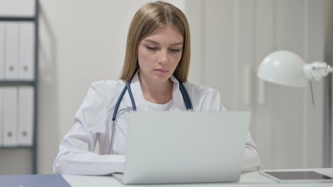 Young Female Doctor Working on Laptop 