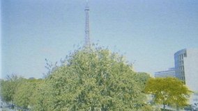 vhs vintage tape effect Aerial fast drone view over Eiffel Tower with calm Seine River tourists boats, streets green trees and homes in heart of Paris seen from above - Powered by Shutterstock - Get 15% off with code: PIKWIZARD15