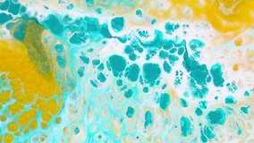 Fluid art drawing video, modern acryl texture with flowing effect. Liquid paint mixing backdrop with splash and swirl. Detailed background motion with turquoise, golden and white overflowing colors.