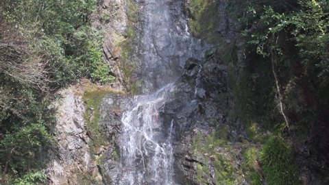 A waterfall that flows with a splash of water.
Water flowing vigorously