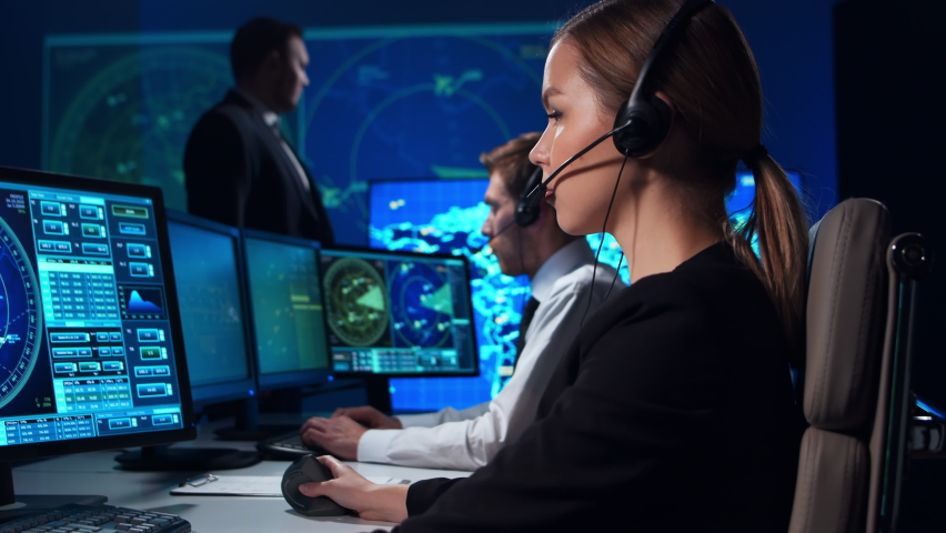 Workplace of the air traffic controllers in the control tower. Team of aircraft control officers works using radar, computer navigation and digital maps. Aviation concept. | Shutterstock HD Video #1064163571