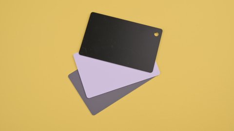The main color of 2021 on cards. Trendy Panton gray on a yellow background. Stopmotion. High quality FullHD footage. High quality FullHD footage