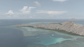 aerial drone footage cloudy sunny weather in padar island, pink beach, komodo island, kanawa island, taka makassar, manta point, tropical paradise labuan bajo flores, wild island of indonesia cinelike