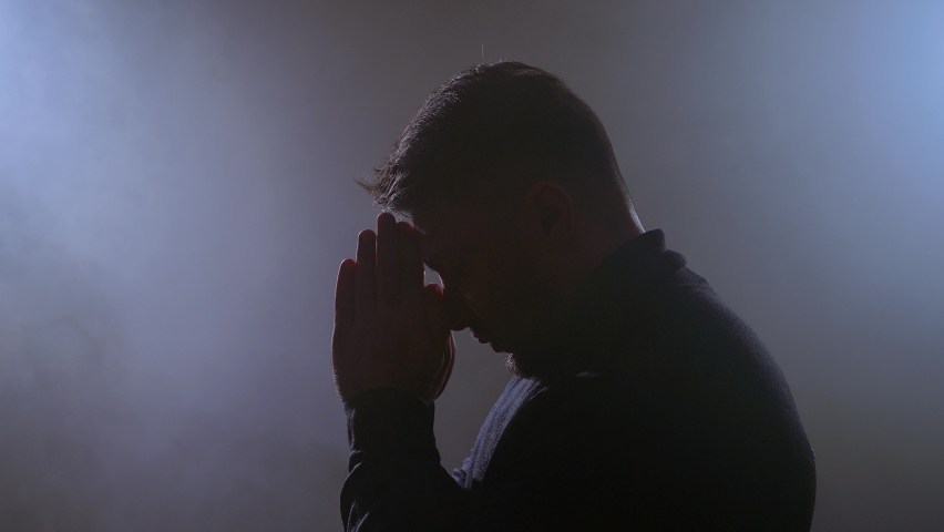 Needy, desperate young man pleading. Man in contemplation. Pray for healing. Faith in god
