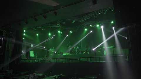 Empty stage concert with colorful lighting laser beam spotlight show in disco pub club bar background for party music dancing festival performance. Entertainment nightlife. Celebration event.