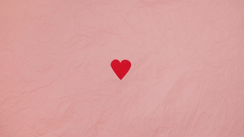 4K stop motion video of heart beating concept. Red paper heart on the pink background. Valentine's Day.