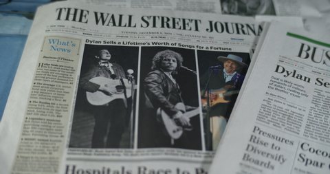 Staten Island, New York  United States - December 16,  2020: Newspaper coverage of singer, song writer Bob Dylan's music catalog being sold to Universal. Front page Wall Street Journal.