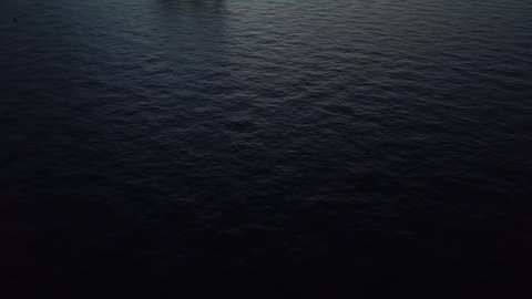 A drone shot of the offshore jack up rig in the middle of the ocean during run rise in the morning
