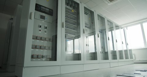 Big modern transformers with glass doors at the factory, control room, 4k