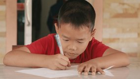 Close-up of boy doing homework. Boy writing something