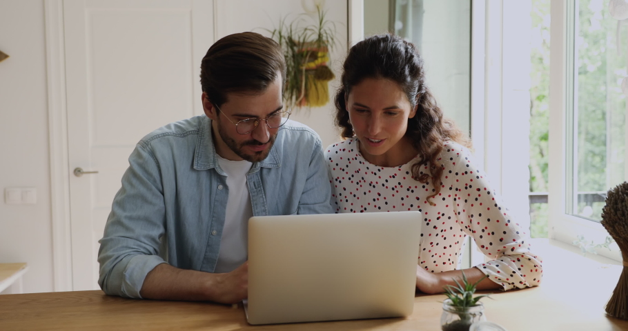 Overjoyed european young family couple looking at computer screen, reading email with good news, placing bets and celebrating online lottery financial win, feeling happiness together at home. Royalty-Free Stock Footage #1064201554