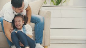 Father has a responsibility to calm down his daughter in 4k slowmotion video.