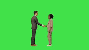 Business man woman inmeet shake hands on a Green Screen, Chroma Key. - Powered by Shutterstock - Get 15% off with code: PIKWIZARD15