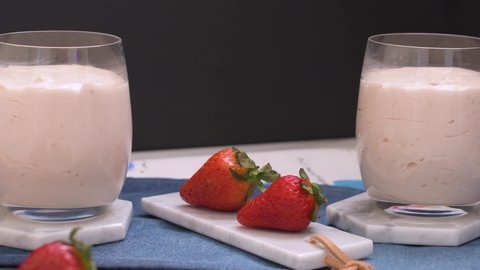 Strawberry mousse on marble on kitchen rags on glasses