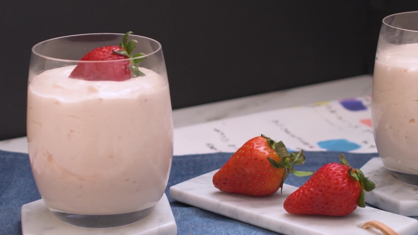 Strawberry mousse on marble on kitchen rags on glasses