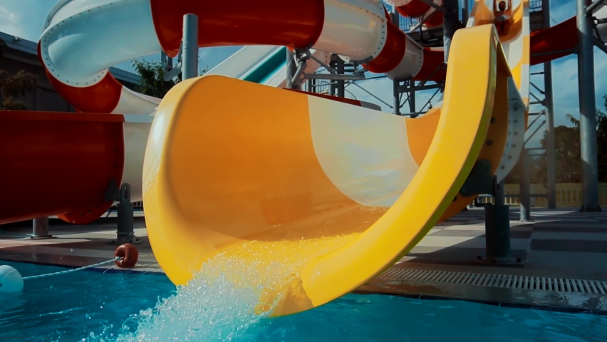 Happy Cheerful Male On Holiday Resort. Summer Vacation Enjoying On Waterslide. Funny Ride On Water Slide Pool In Water Park. Sliding Down In Waterpark. Man Having Fun On Water Slides Aqua Park Glides Royalty-Free Stock Footage #1064223502