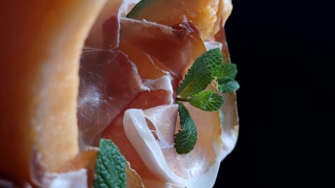 Honeydew melon with ham and mint leaves