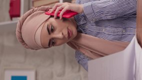 Angry confident business woman in turban talking on the phone, annoyed woman having conflict during phone call at home. Angry woman talking with customer representative on mobile phone.