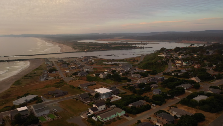 Houses by the jetty in Bandon Oregon, aerial view of Coquille River and lighthouse, as well as Bullard