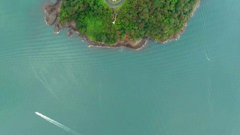 Beautiful cinematic aerial view of the Causeway in Panama and the City with skyscrapers at the end