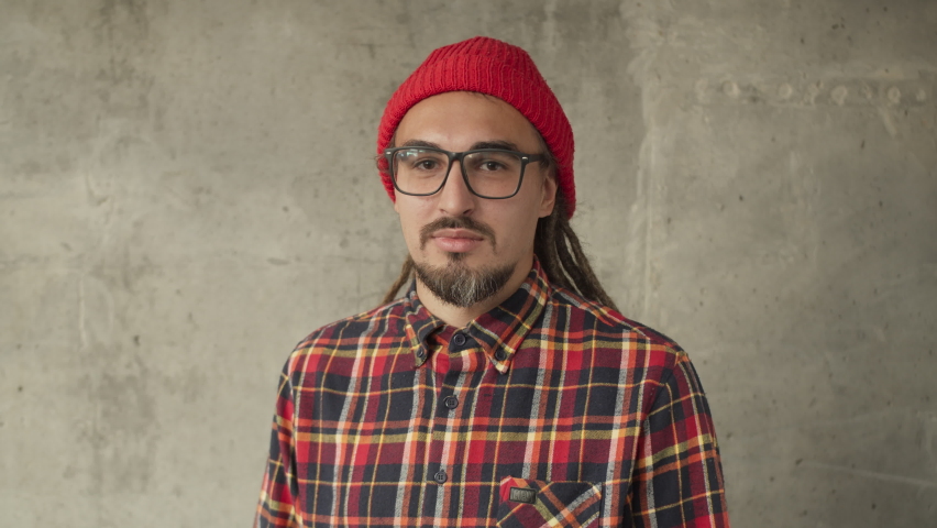 Attractive man using his smartwatch and controlling his smart home, hipster freelancer use smart watch