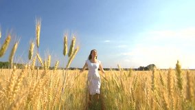 Beauty girl running on yellow wheat field. Freedom concept. Happy woman outdoors. Harvest. Wheat field in sunset. Slow motion 240 fps. Slowmo. 1080p full HD video footage 
