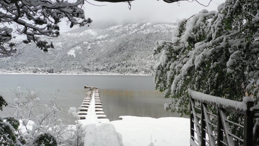 Snow covered floating dock at Moreno lake with mountain view. Bariloche , Patagonia Argentina