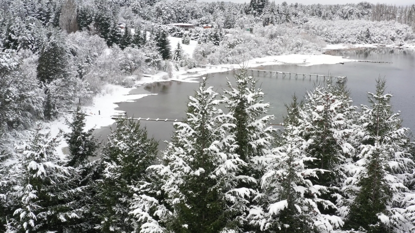 Drone aerial view of docks on Moreno Lake during a snowfall. Bariloche, Patagonia Argentina 