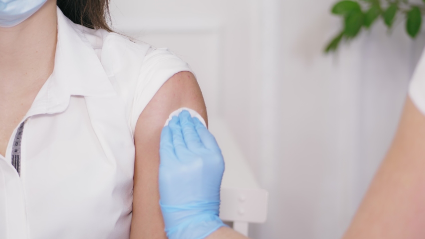 Coronavirus Vaccination. close-up, nurse, in blue protective gloves, makes vaccination with vaccine syringe. vaccination procedure. vaccine against coronavirus. | Shutterstock HD Video #1064290867