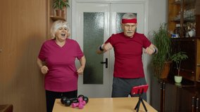Senior elderly couple man and woman exercising. Old grandmother grandfather doing healthy lifestyle workout, training, fitness, sport activity at home. Trainers shoots video blog trainings online vlog