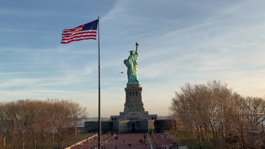 People walking in the park behind the Statue of Liberty, Liberty Island, USA