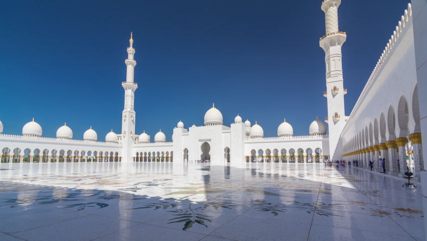 Sheikh Zayed Grand Mosque timelapse hyperlapse in Abu Dhabi, the capital city of United Arab Emirates. Inner court yard. Blue sky at sunny day Royalty-Free Stock Footage #1064305990