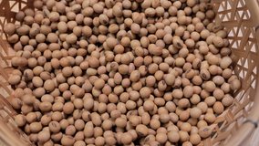 Raw soybean seed food organic top view texture, High in fiber, helps prevent cancer, supplementary food, Protein healthy food, video footage, Close-Up Shot of Soybean Falling, slow motion.