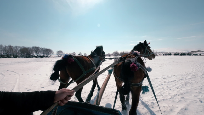 Sleigh ride on frozen lake in snowy weather. Harsh winter type. Ardahan city in Turkey.