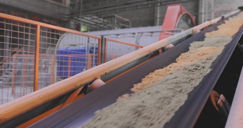 Conveyor belt line at the factory, conveyor belt with sand and metal balls