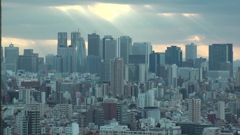 TOKYO, JAPAN : Aerial high angle sunset CITYSCAPE of TOKYO. View of office buildings at downtown area around Shinjuku. Japanese urban metropolis concept. Long time lapse shot dusk to night.
