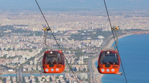 Cable car in Antalya, Turkey. Cable car cabins with Antalya cityscape, Konyyalti beach and Mediterranean sea at background. 