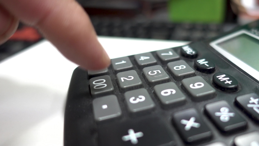 Horizontal video of young male using a calculator. Business accounting and financial concept. Calculating debts and earnings. Person working with classic digital calculator. | Shutterstock HD Video #1064335159