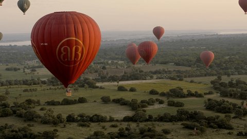 Bagan, Myanmar, December 2019: Hot air balloon flying above archeological zone at sunrise View of Bagan temples and balloons from the air 
