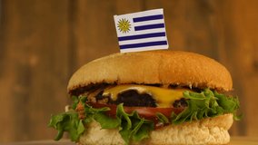 Delicious burger with small Uruguayan flag on top of them with toothpicks. Yummy juicy hamburger rotating. - Powered by Shutterstock - Get 15% off with code: PIKWIZARD15
