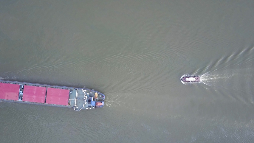 A ship on the river. Small ship sails on the river, aerial view