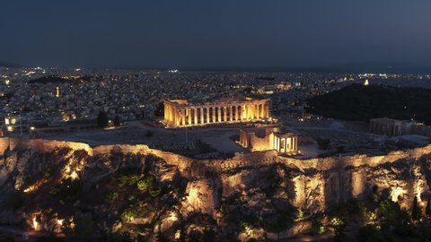 Establishing Aerial View Shot of Athens, Parthenon, ancient Acropolis, Greece at night evening
