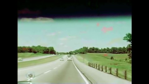 CIRCA 1970s - Scenery taken from inside a car on a road trip along a highway in Indiana, the United States, in 1976.