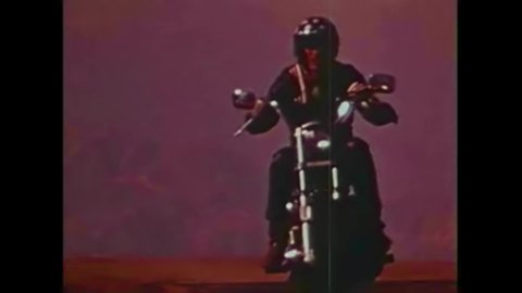 CIRCA 1970s - A man on a Harley Davidson motorcycle drives across country in the opening sequence to a 1973 motorcycle safety film.