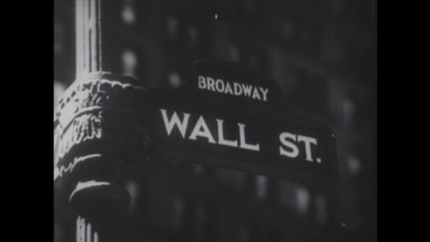CIRCA 1950s - Shots of Wall Street and unemployed people in employment lines in the 1930s