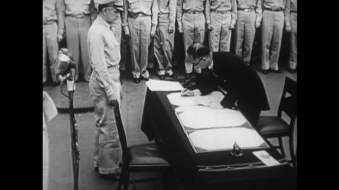 CIRCA 1950s - Japanese foreign affairs minister Shigemitsu signs the surrender agreement with General MacArthur on the deck of the USS Missouri.