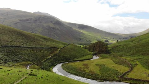Aerial Drone tracking shot of Mosedale Beck looking to Wasdale, Lake District, UK