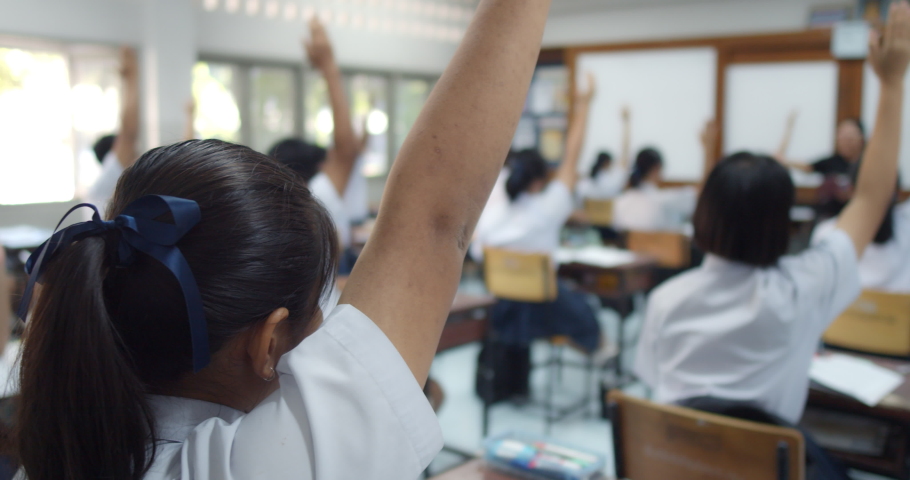 Slow motion of Asian high school students in white uniform actively study science by raising their hands to answer questions that teachers ask them  in classroom. | Shutterstock HD Video #1064396866