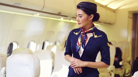 Cabin crew or air hostess working in airplane . Airline transportation and tourism concept.