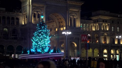 Panorama of Piazza Duomo square on New Year's and Christmas tree. Albero di Natale with colored lights. City at night. One night ahead. Multi-colored lights. Milan, Italy, December 2020:
